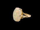 An 18 carat yellow gold* dress ring set with a large oval opal gemstone. side