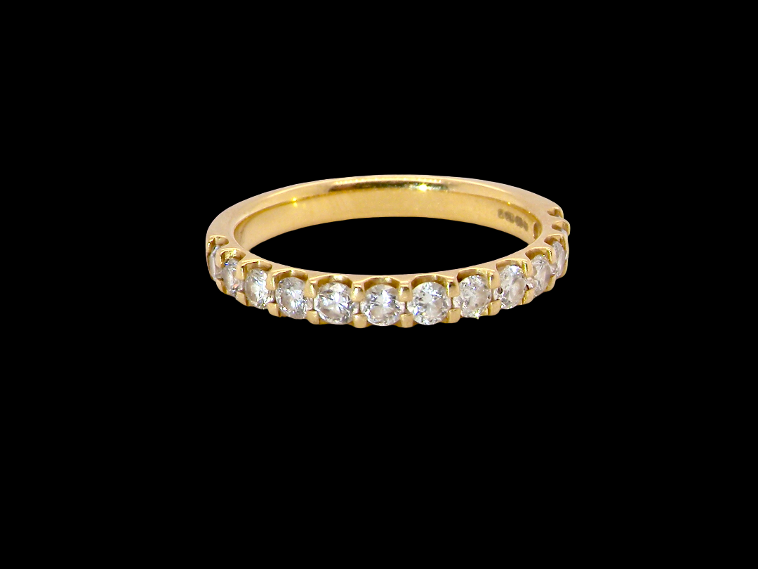 An 18 carat yellow gold half hoop diamond eternity ring originally purchased from Goldsmiths 
