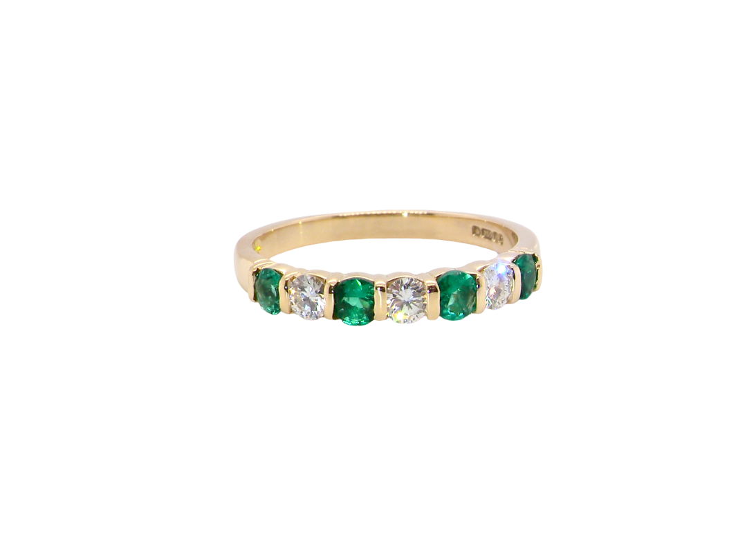 Emerald and diamond half eternity ring