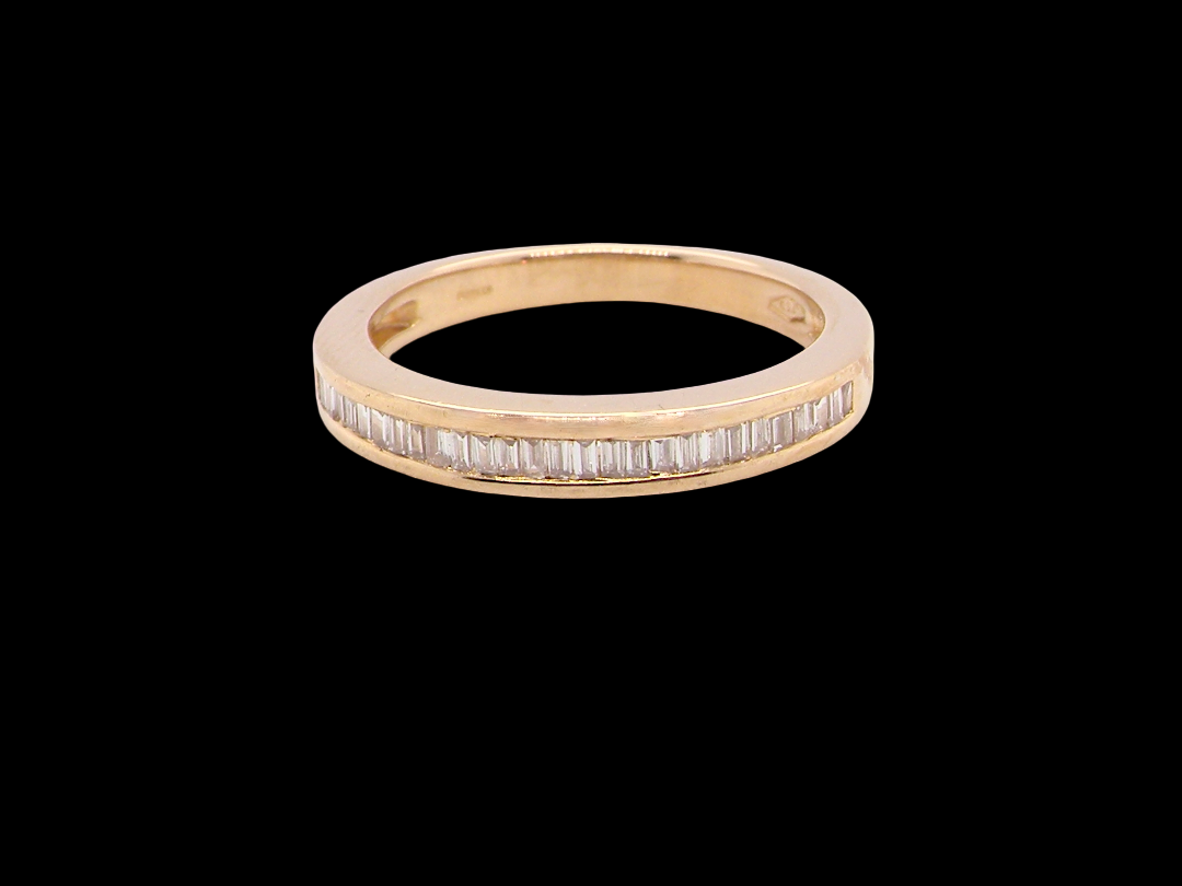 An 18 carat yellow gold half hoop eternity ring.

Set with thirty baguette cut diamonds, 