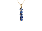 An 18 carat yellow gold pendant. This features five oval cut mid cornflower blue sapphires, 
