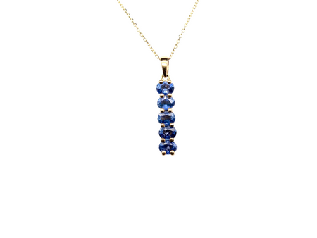 An 18 carat yellow gold pendant. This features five oval cut mid cornflower blue sapphires, each 5x3.5mm.&nbsp;
