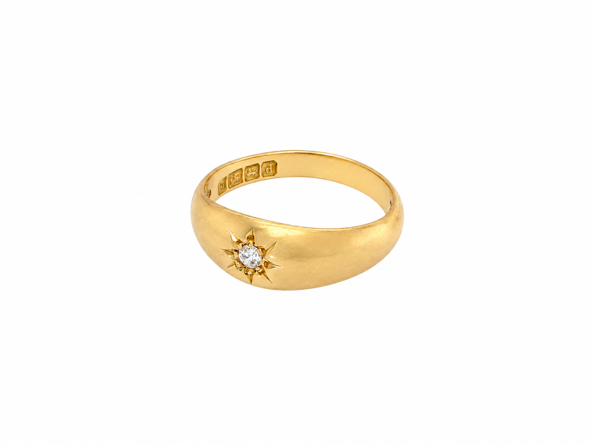 An 18 carat yellow gold ring, sometimes referred to as a 'gypsy' ring. The diamond measures 2.4mm (0.05 carats) star set.