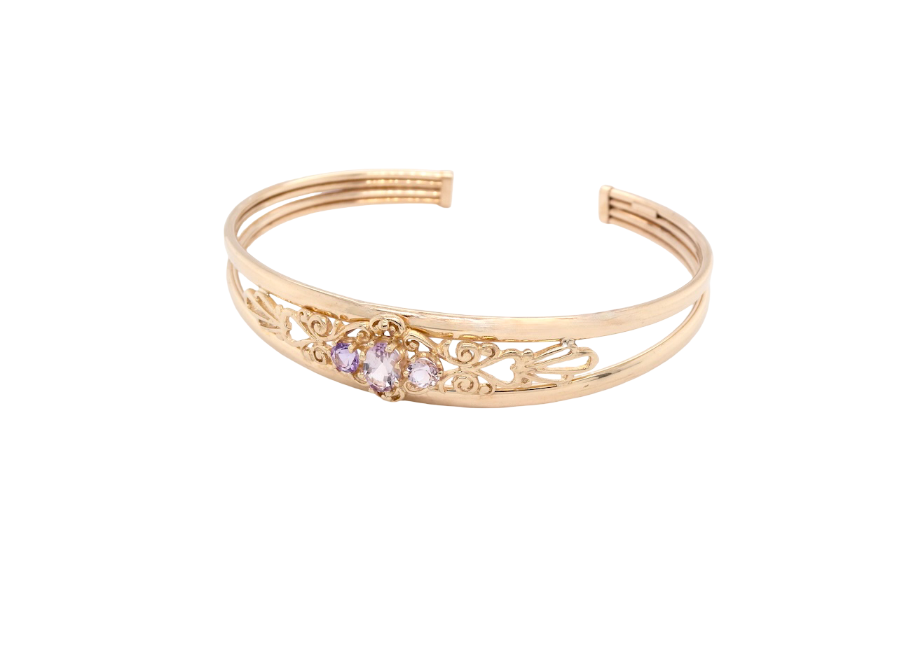 Gold bracelet with decorative elements and small stones on a white background
