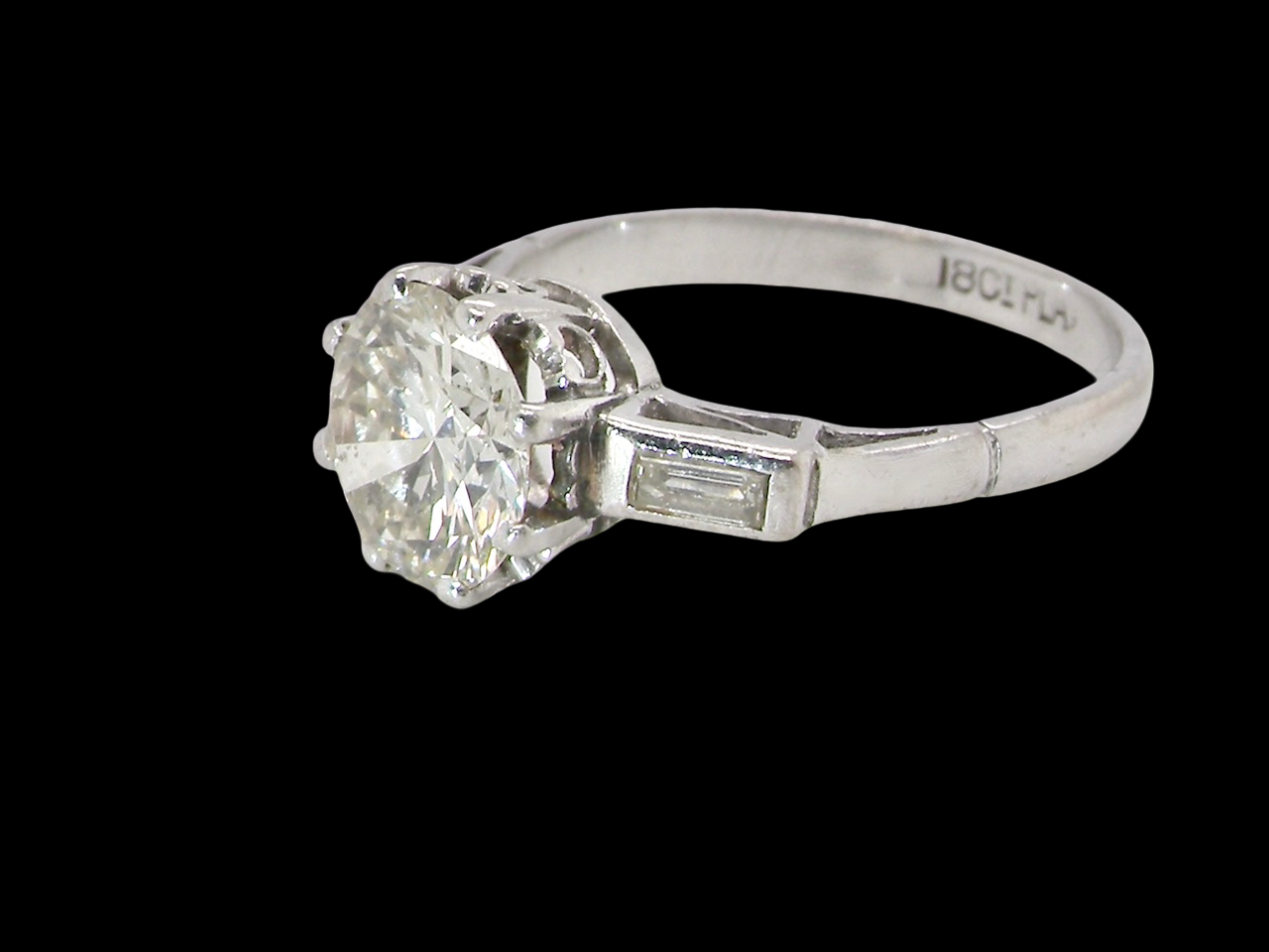 An Art Deco solitaire ring showcasing a beautiful 1.75 carat diamond side