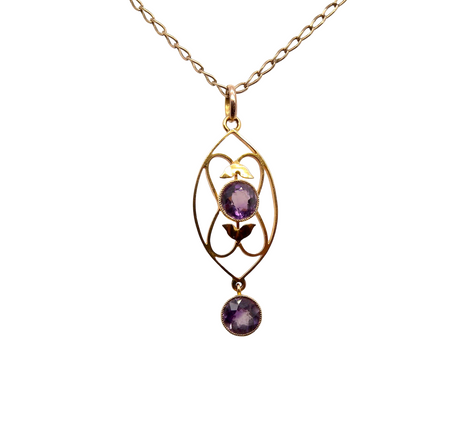 An Edwardian pendant set with two amethyst gemstones