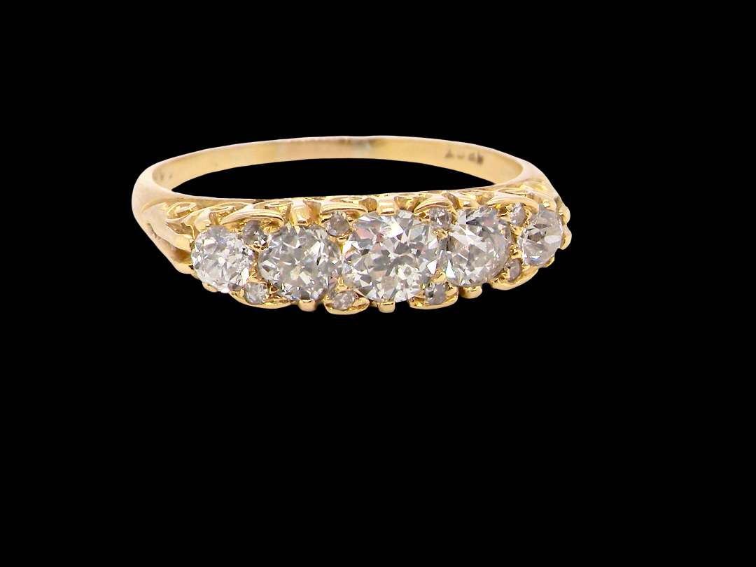 An antique boat shaped five stone ring. Set with five old cut white diamonds. Centre 5mm (0.45-0.50 carats) each side a 4mm stone, at each end a 2.4mm stone. Total diamond content estimated at one carat.