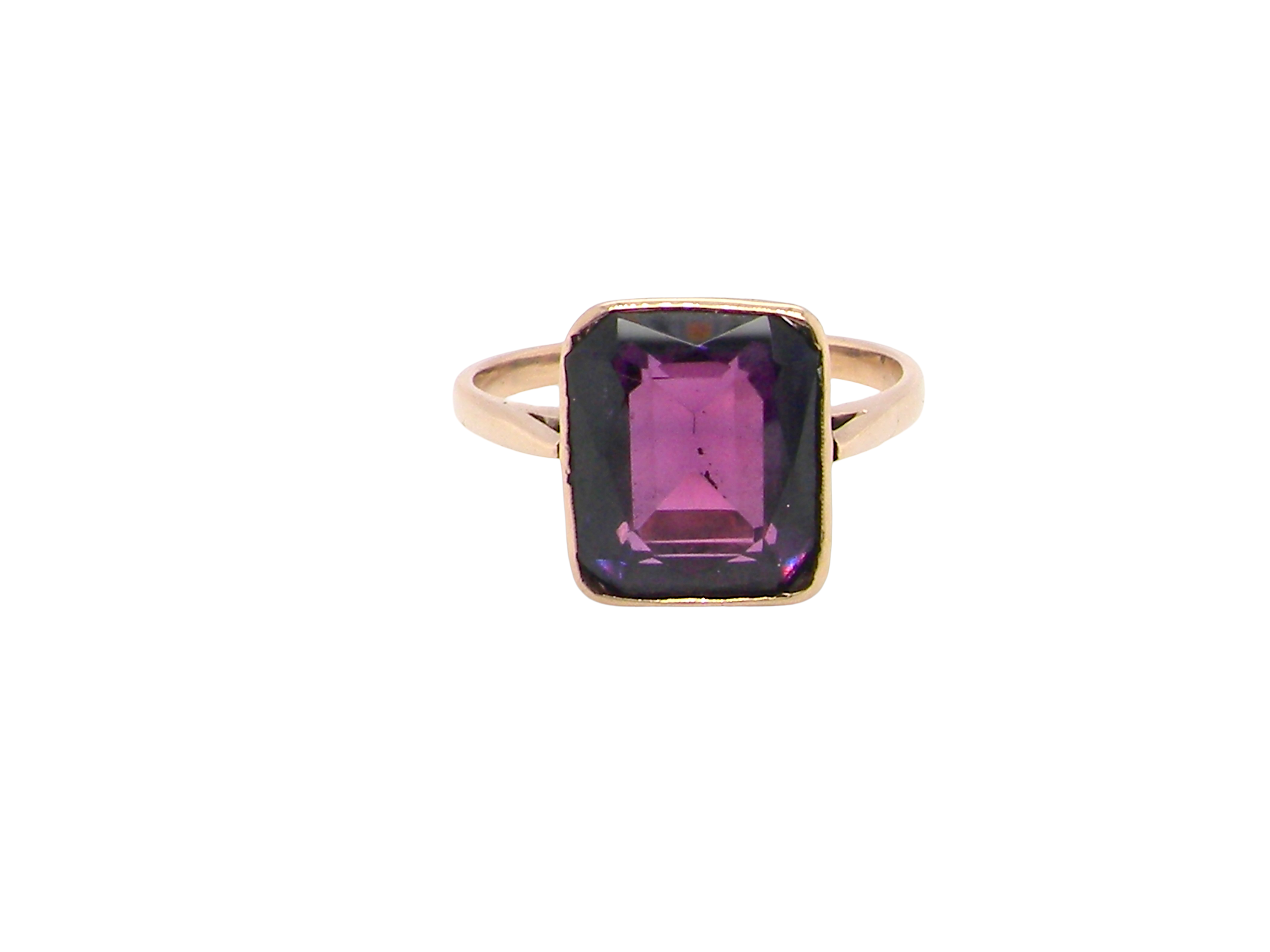 An antique dress ring that features a rectangular cut amethyst. Very dark purple, measures 12x10mm. Rim setting.
