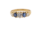 An antique ring from the early years of the 20th century. Centre stone 5mm diameter (0.50 carats) Colour H-j, clarity Si. Each side&nbsp;  blue sapphire 4mm diameter.
