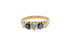 An antique ring from the early years of the 20th century. Centre stone 5mm diameter (0.50 carats) Colour H-j, clarity Si. Each side&nbsp; a mid colour blue sapphire 4mm diameter.
