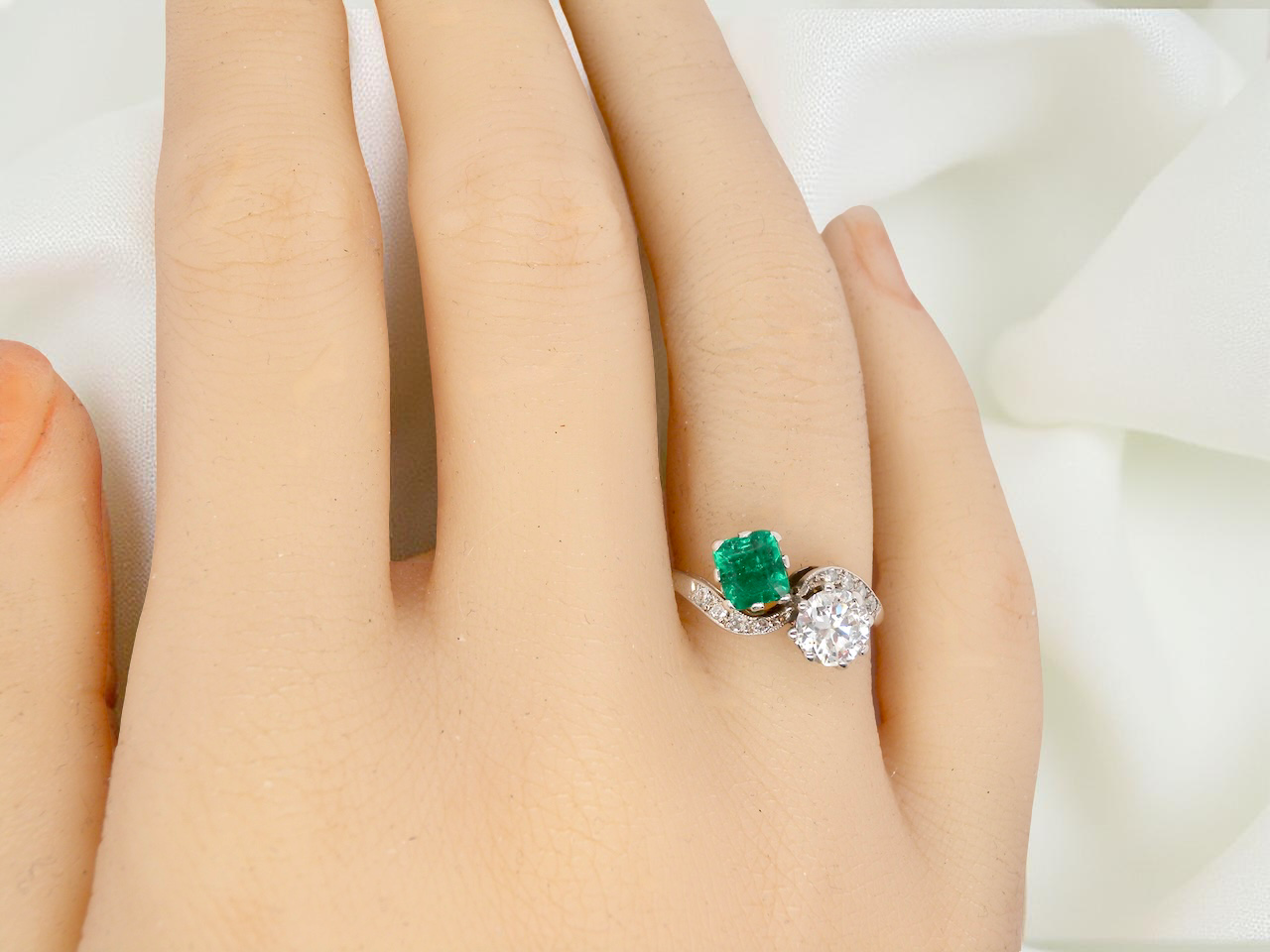 An antique two stone Emerald and Diamond ring