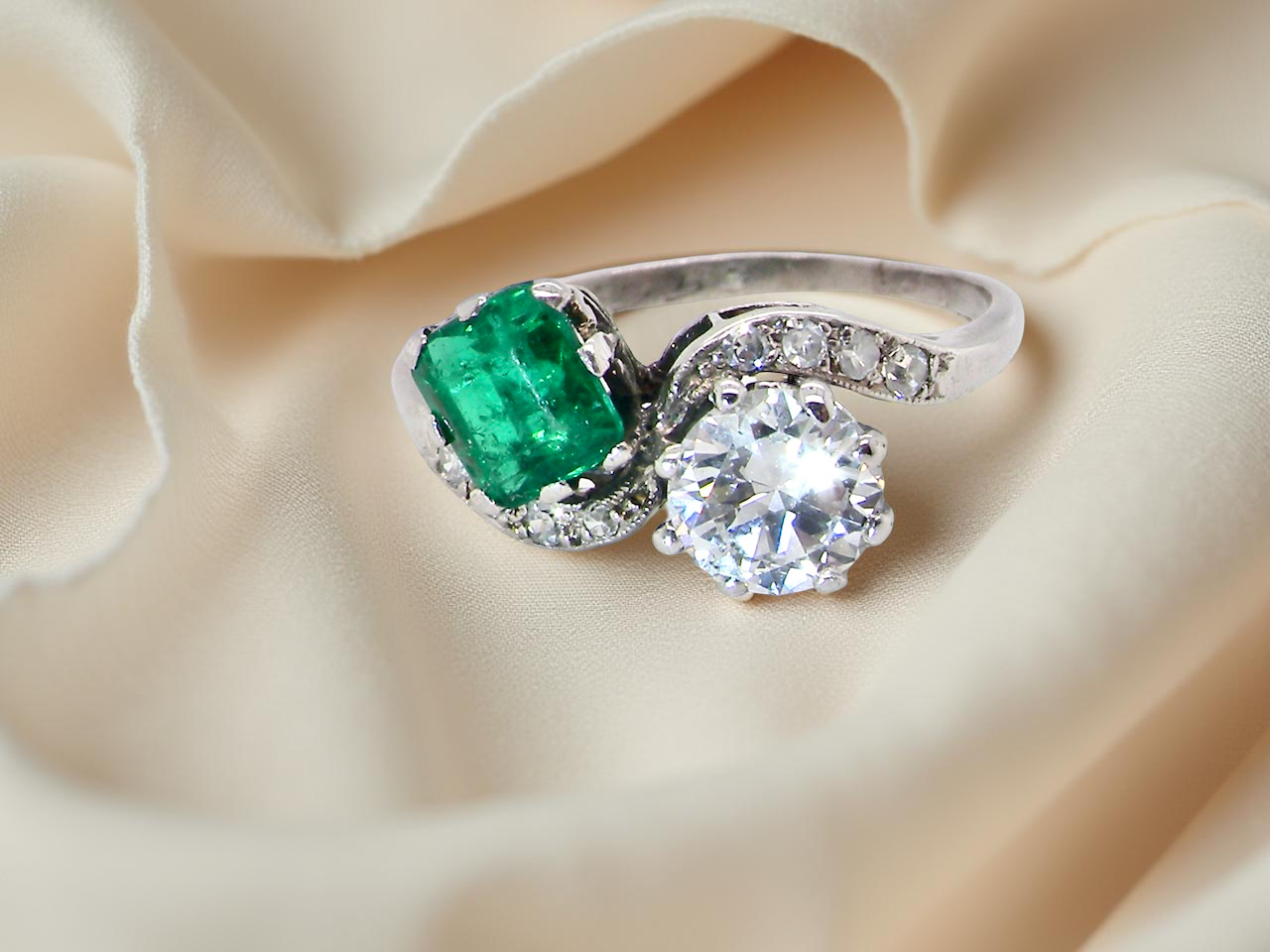 An antique two stone Emerald and Diamond ring