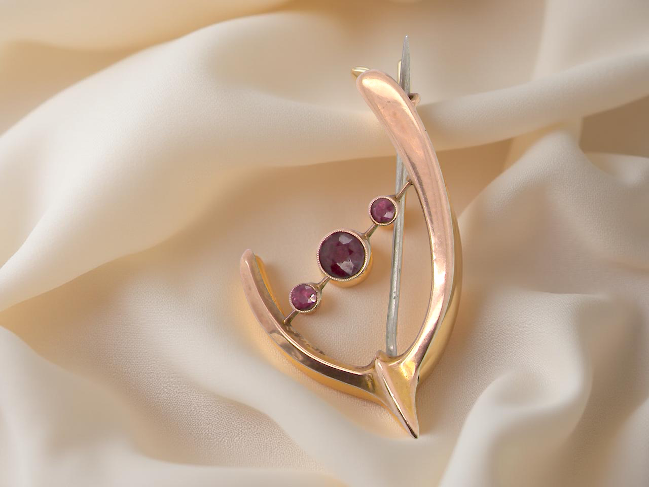 An antique wishbone shaped brooch