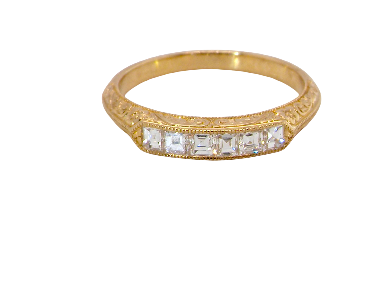 An attractive half hoop diamond eternity ring. Set with six step cut white diamonds, sit side by side, the colour estimated at H-i, clarity Si.