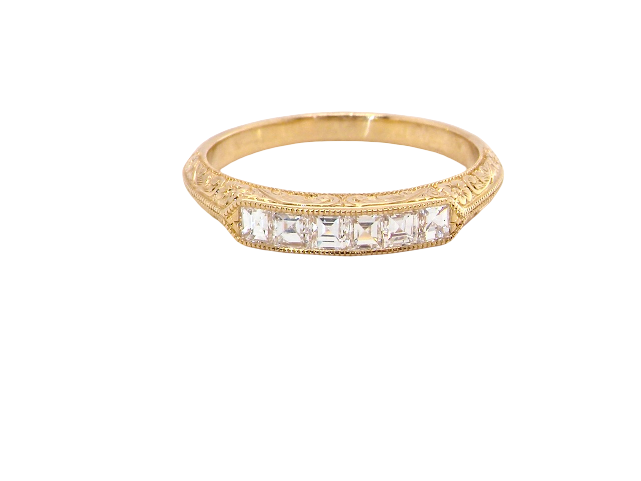 An attractive half hoop diamond eternity ring. Set with six step cut white diamonds, sit side by side, the colour estimated at H-i, clarity Si.