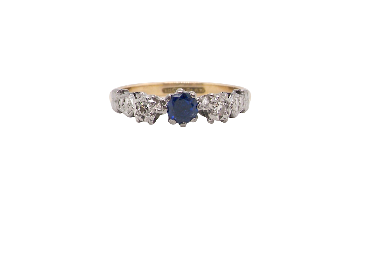 An early 20th century engagement ring. The centre stone a dark blue sapphire