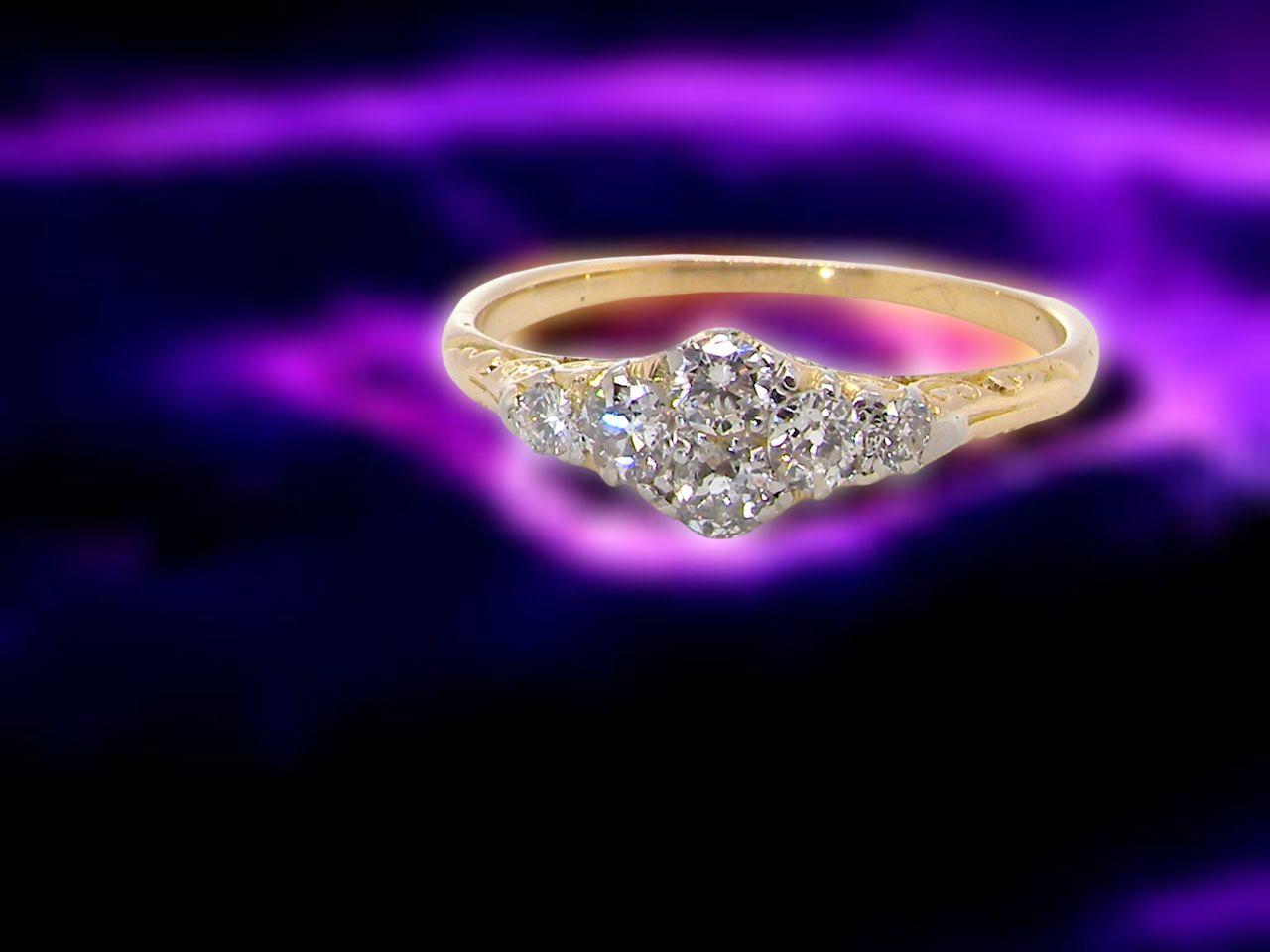 An early 20th century ring set with old brilliant cut diamonds.

Centre is set with 4 diamonds,