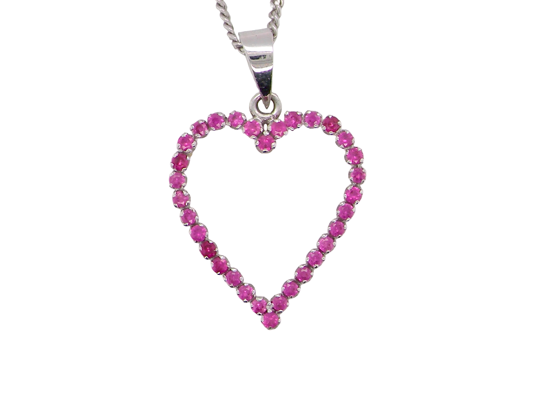 An elegant and beautifully crafted open heart pendant, set with a delightful arrangement of delicate pink sapphires, 