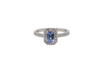An elegant cluster ring that features to the centre a rectangular tanzanite gemstone that measures 6x4mm (est 0.50 carats) AAA colour.