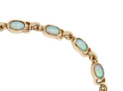 An elegant line bracelet set with fourteen oval opals, each measuring approximately 5 x 3 mm, displaying a good  and lively play of colour.