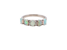An elegant opal and diamond half hoop ring, featuring five oval opals with lively play of colour. Each opal measures 5 x 3mm, with an estimated total opal weight of approximately 0.75 carats, all claw set 