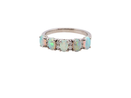 An elegant opal and diamond half hoop ring, featuring five oval opals with lively play of colour. Each opal measures 5 x 3mm, with an estimated total opal weight of approximately 0.75 carats, all claw set 