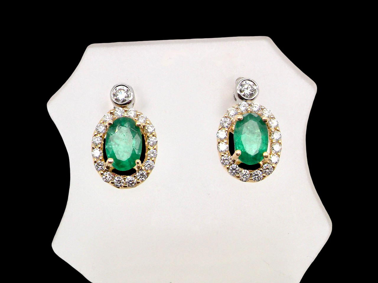 An elegant pair of emerald and diamond drop earrings, crafted in 18 carat gold.