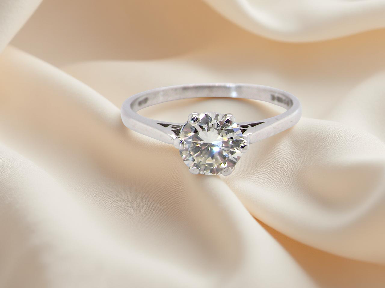 An elegant single-stone solitaire ring set with an exceptional brilliant-cut white diamond, estimated at 0.91 carats. 