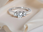 An elegant trilogy ring set with three brilliant-cut  diamonds, 