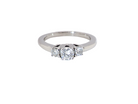 An elegant trilogy ring set with three brilliant-cut white diamonds, 
