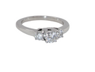 An elegant trilogy ring set with three brilliant-cut white diamonds,  side