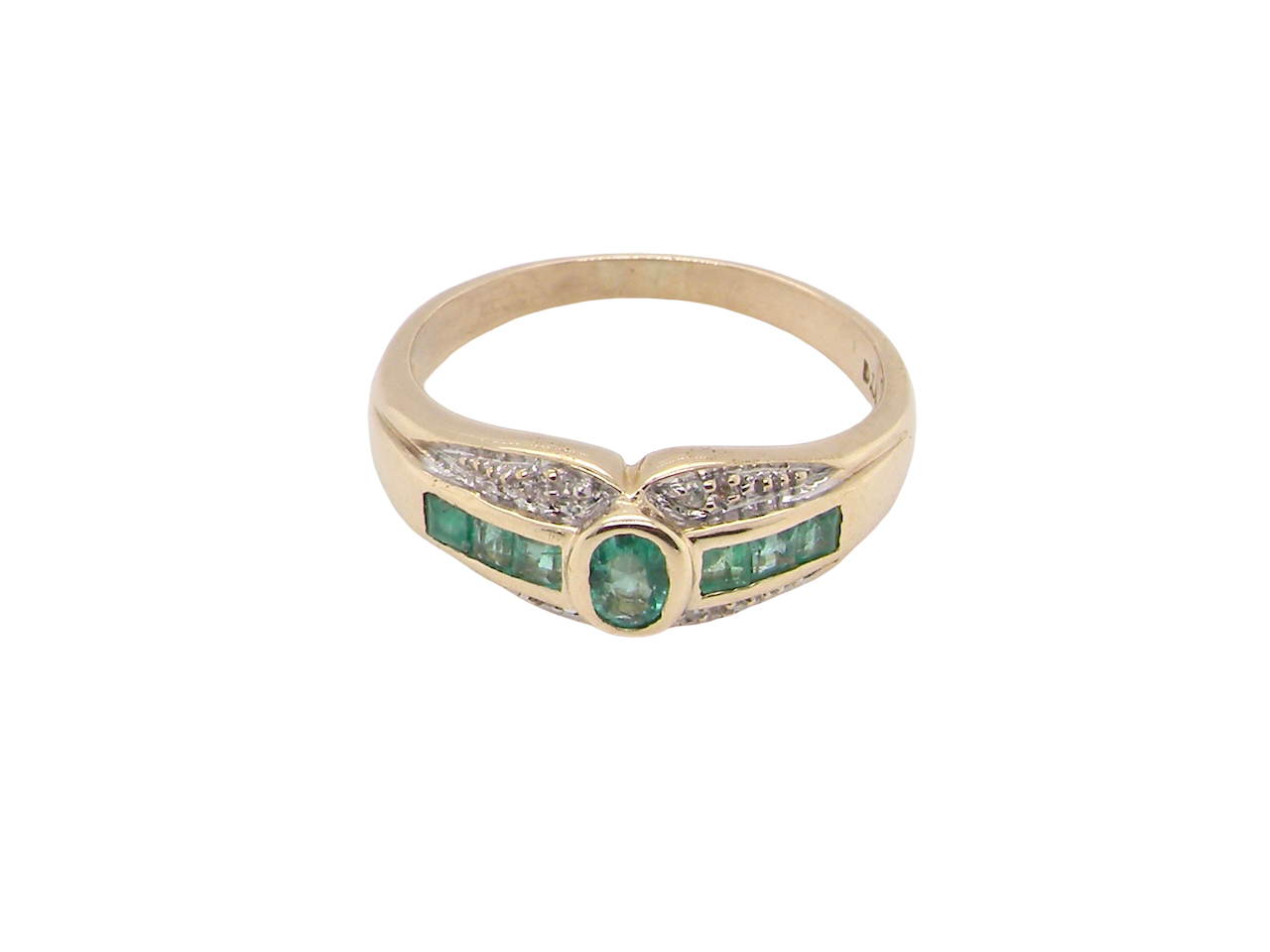 An emerald and diamond dress ring