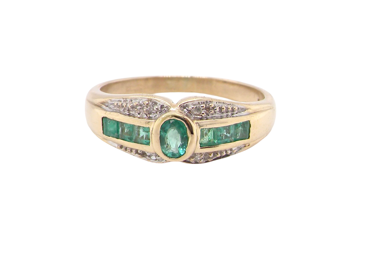 An emerald and diamond dress ring