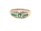An emerald and diamond dress ring