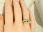 An emerald and diamond dress ring