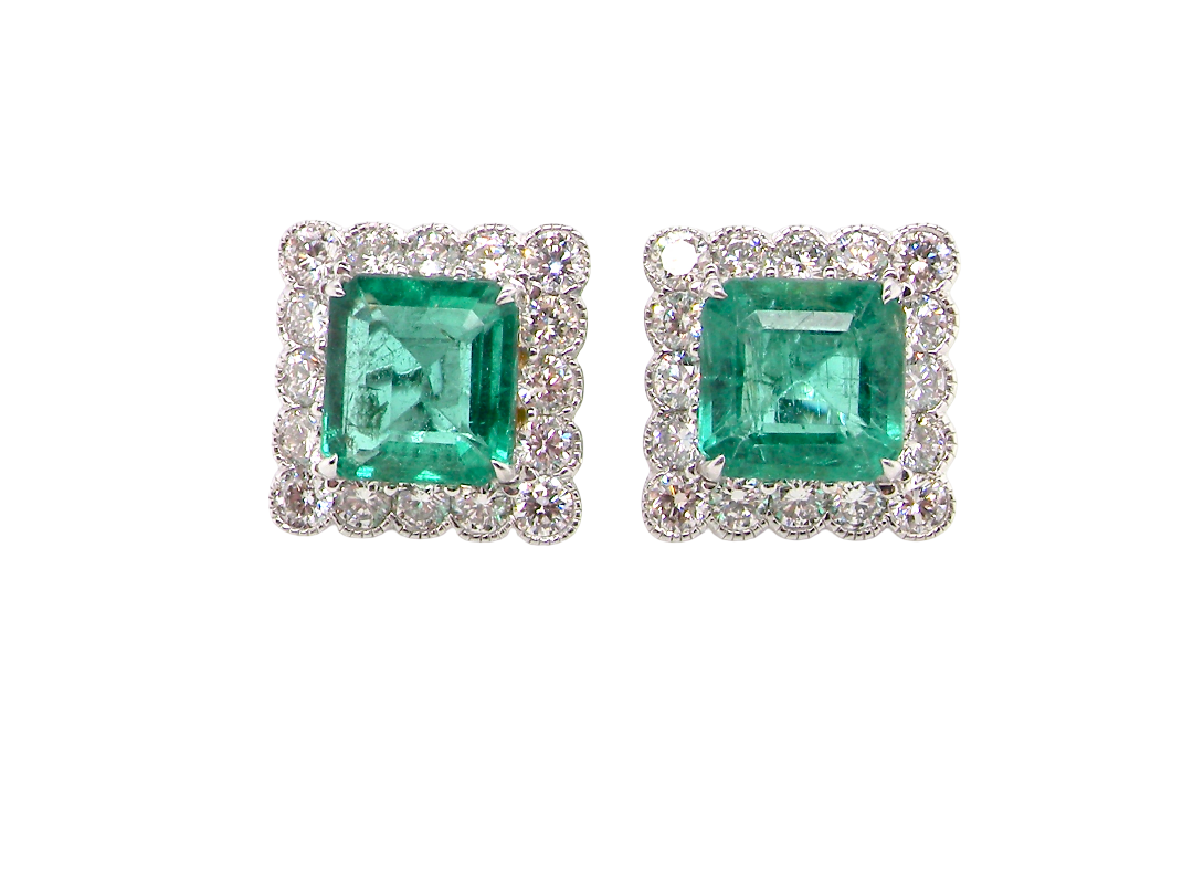 An exceptional pair of cluster earrings. Each of these beautiful earrings is set with a stunning square cut emerald, measures 7x7mm