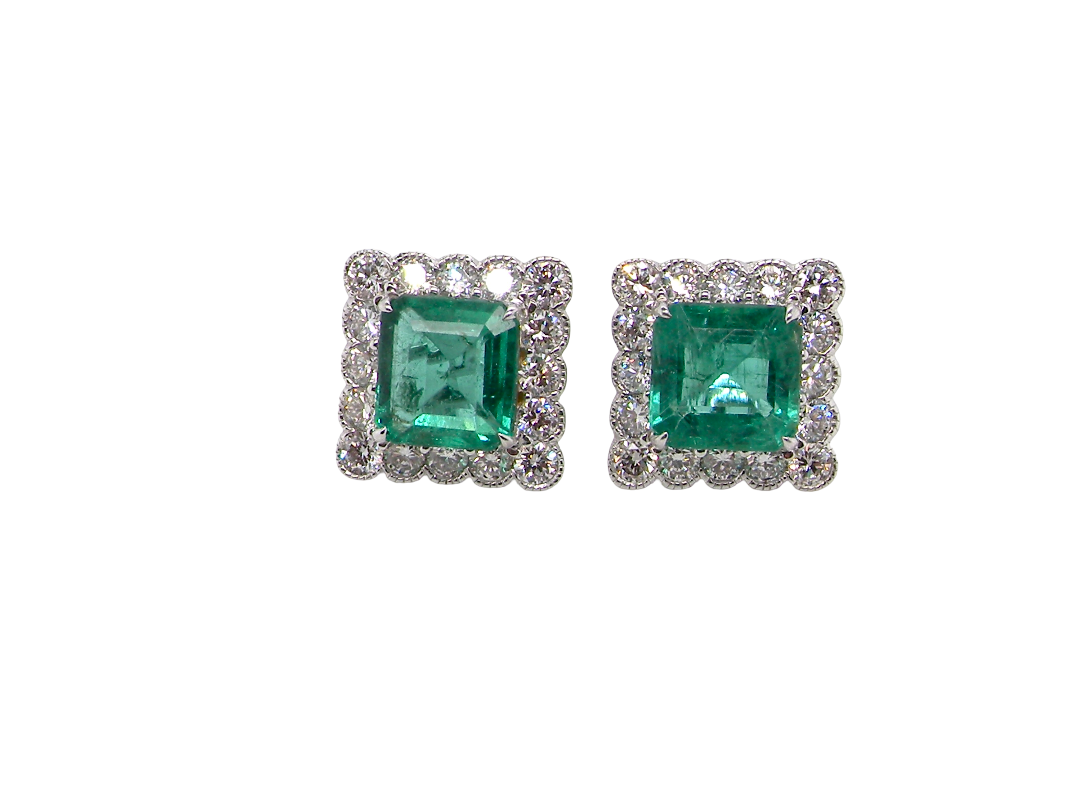 An exceptional pair of cluster earrings. Each of these beautiful earrings is set with a stunning square cut emerald, measures 7x7mm (est carat size 1.8 carats) excellent colour 