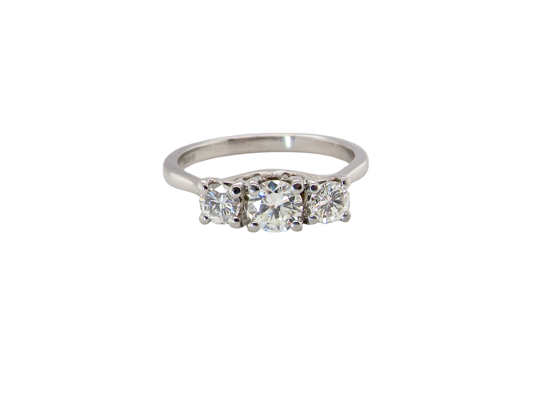 An exceptional three stone diamond trilogy ring, beautifully crafted in platinum and set with three modern brilliant cut white diamonds.