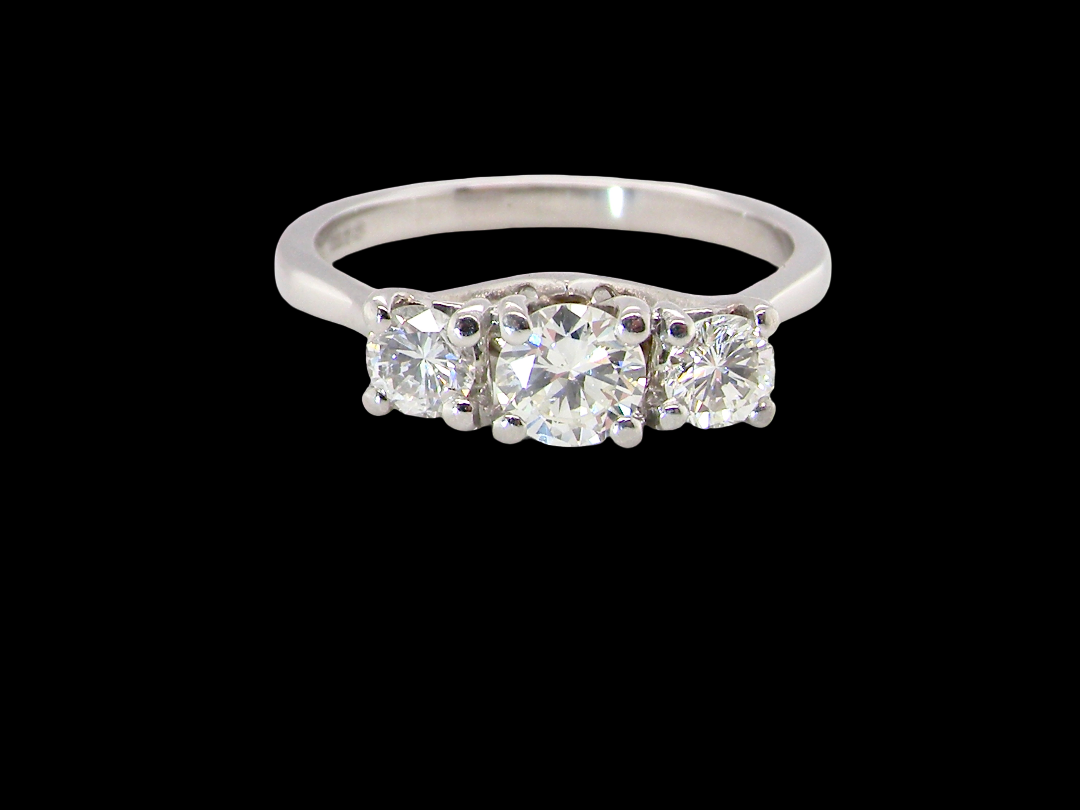 An exceptional three stone diamond trilogy ring, beautifully crafted in platinum and set with white diamonds.