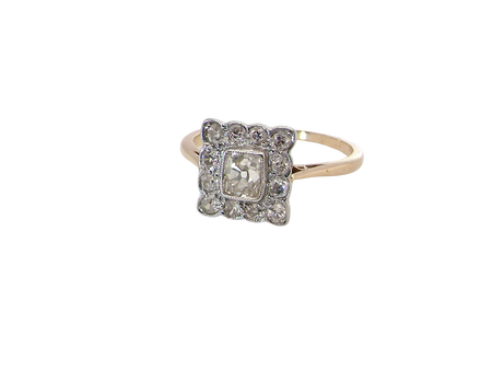  An exquisite Art Deco diamond cluster ring, beautifully handcrafted and rich in period charm.

At its centre sits a striking rectangular cut diamond measuring approximately 5 x 4.8mm, estimated at 0.50 carats, 