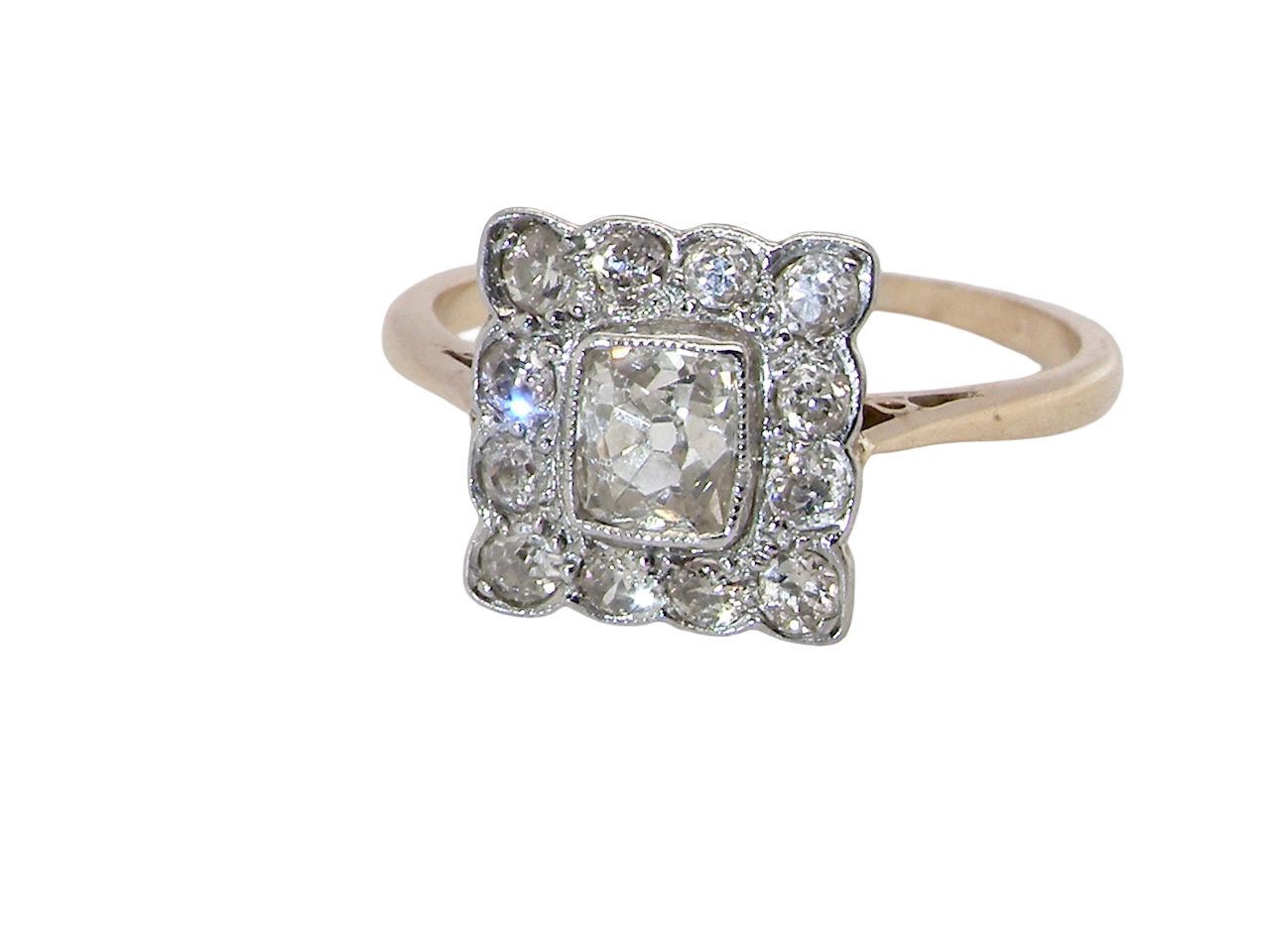  An exquisite Art Deco diamond cluster ring, beautifully handcrafted and rich in period charm.

At its centre sits a striking rectangular cut diamond measuring approximately 5 x 4.8mm, estimated at 0.50 carats, 