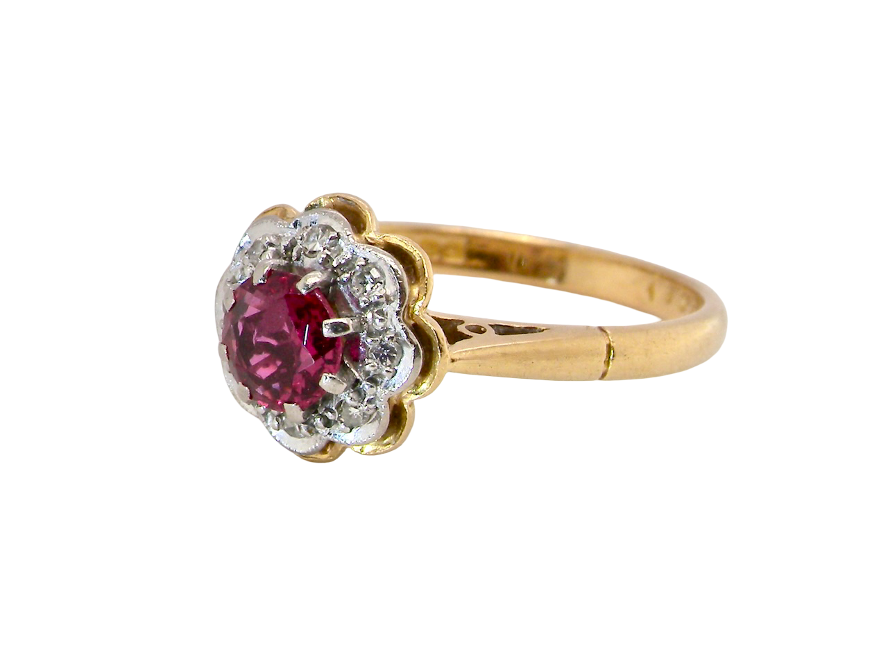 An exquisite vintage cluster ring centred around a&nbsp; 5 mm ruby,( 0.50 carats)  side