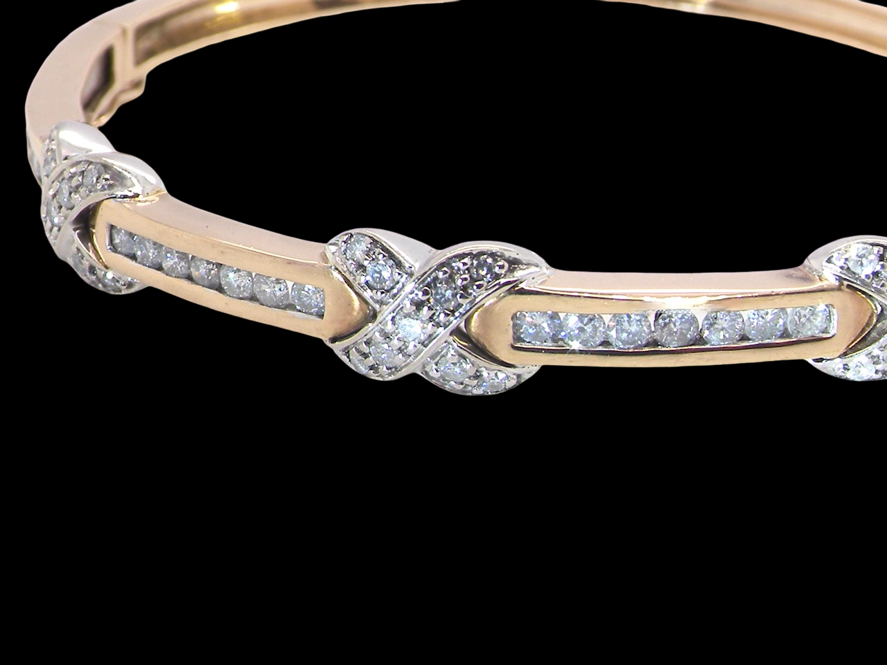 An impressive 9 carat gold bangle.&nbsp;

Three 'kiss' shaped sections , each set with nine brilliant cut white diamonds kiss sections