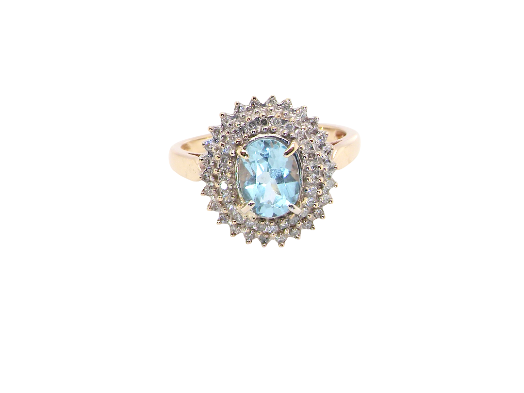 An impressive cluster ring that features to the centre an oval cut blue topaz gemstone, 8x6mm sky blue colour.

Complimented by an outer double halo of diamonds
