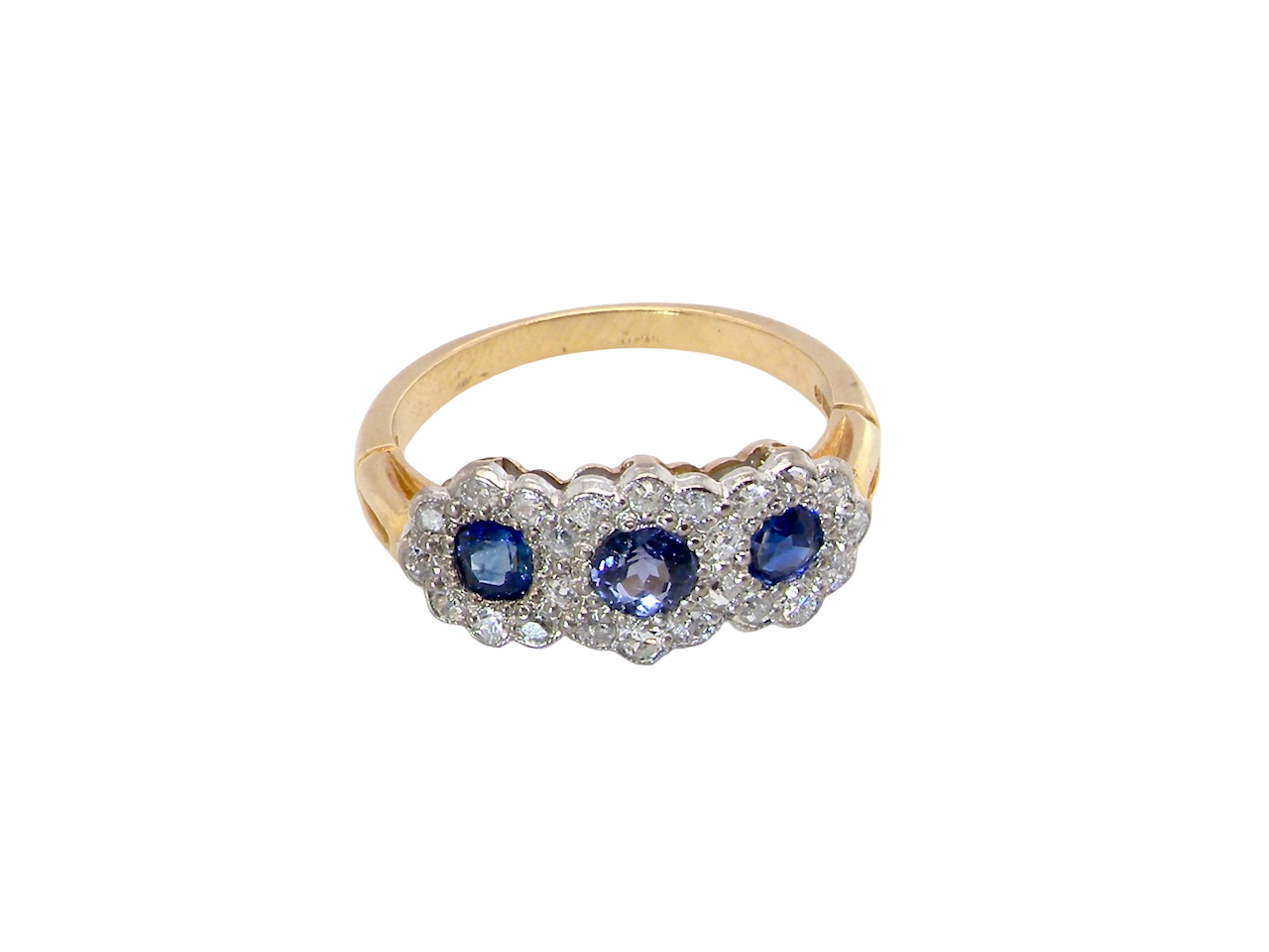 An impressive multi cluster ring. Set with three cornflower blue sapphires to each centre, 4.3mm, and each side a 3.3mm sapphire. 