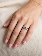 An impressive multi cluster ring. Set with three cornflower blue sapphires to each centre, 4.3mm, and each side a 3.3mm sapphire. Based on an Edwardian design
hand