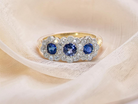 An impressive multi cluster ring. Set with three cornflower blue sapphires to each centre, 4.3mm, and each side a 3.3mm sapphire.  Edwardian design
