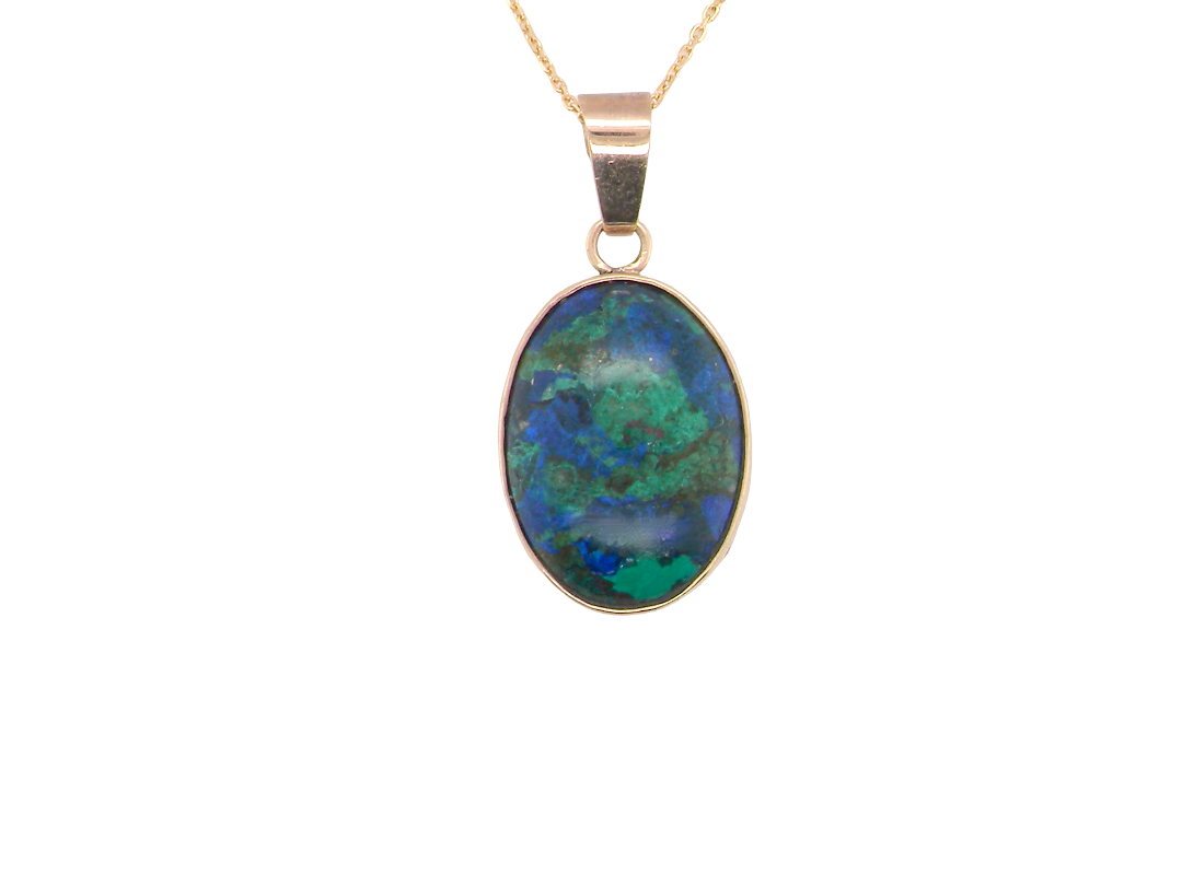 An interesting pendant set with an azurmalachite semi precious gem stone. Measures 20x15mm. Gold rim edged setting, with a V shaped bale. (tests as 9 carat gold)&nbsp;