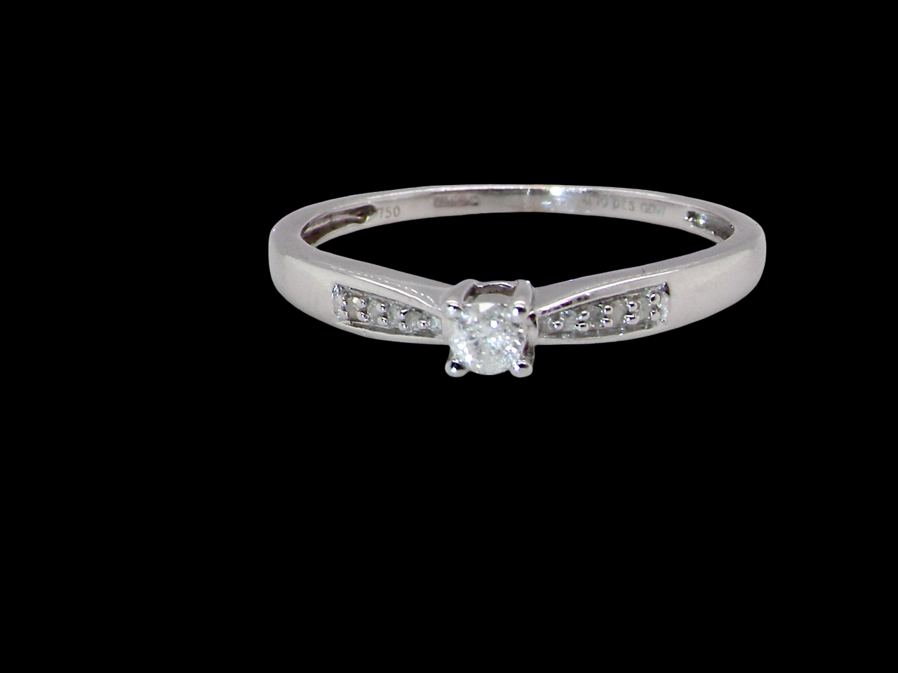 An&nbsp; 18 carat white gold solitaire ring set with a central round brilliant-cut diamond measuring 2.8mm (0.08 carats)