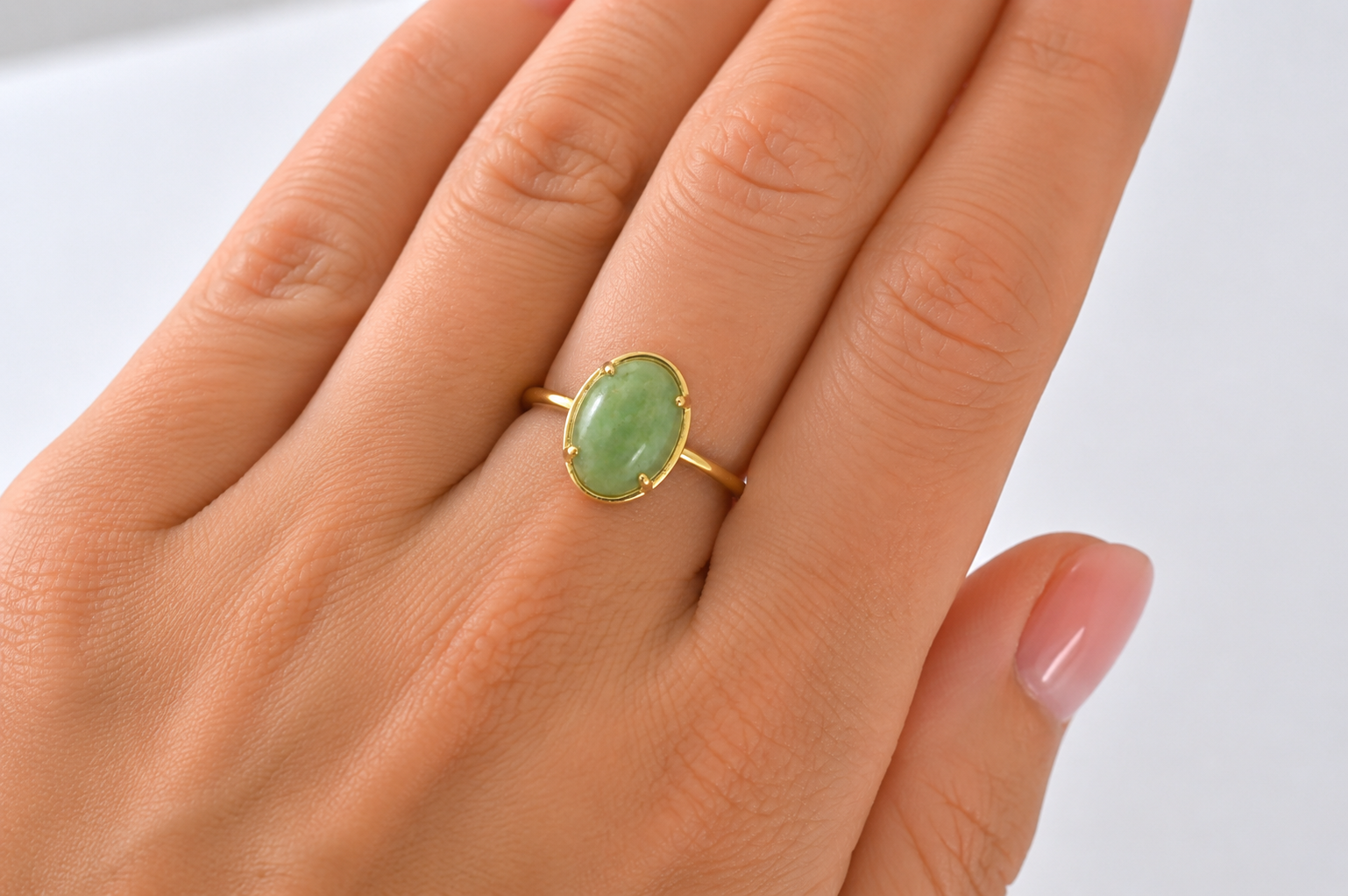 An oval jade nephrite ring on hand